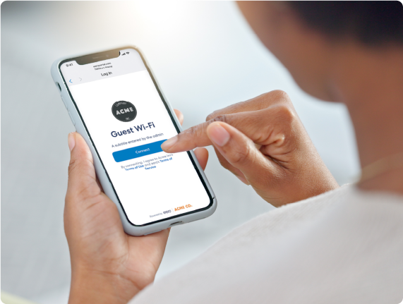 person holding mobile device in hand with guest wifi displayed on screen
