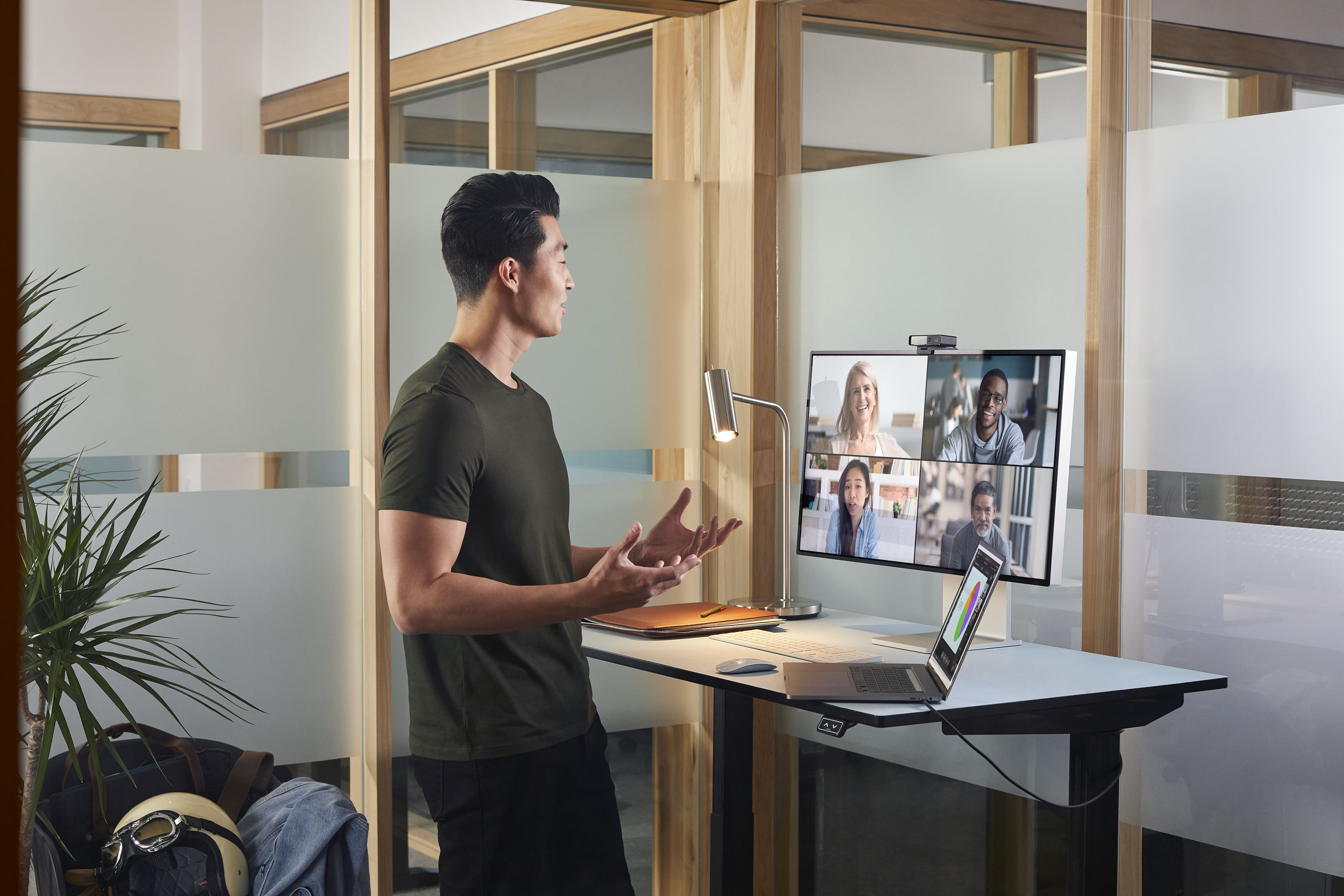 Man standing in front of computer on a video conference